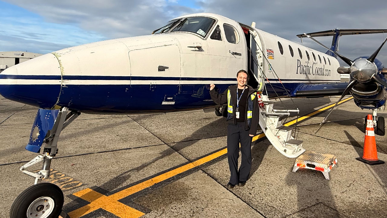 female pilot in front of a jet
